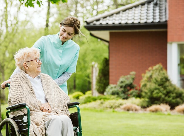 senior-disabled-woman-with-caregiver-in-the